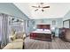 A beautiful main bedroom features a large window and an elegant dark wood furniture set at 2848 Wilshire Rd, Clermont, FL 34714