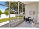 View of the screened-in patio area with a table, chairs, and view of the backyard at 2848 Wilshire Rd, Clermont, FL 34714