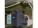 Aerial view of a home with a dark roof and pool in the backyard at 3306 Fishermans Cv, Winter Park, FL 32792