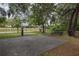 Backyard basketball court area with picnic tables under the shade of beautiful mature trees at 3306 Fishermans Cv, Winter Park, FL 32792