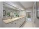 Bright bathroom with white cabinets, granite countertops, and large mirrors for natural light at 3306 Fishermans Cv, Winter Park, FL 32792