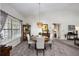 Cozy dining room with a round table, elegant chandelier, and natural light from the window at 3306 Fishermans Cv, Winter Park, FL 32792