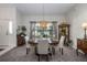Elegant dining room with a round table, chandelier, and large window providing natural light at 3306 Fishermans Cv, Winter Park, FL 32792