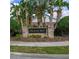A brick sign for the Pelican Bay community is surrounded by lush landscaping and palm trees at 3306 Fishermans Cv, Winter Park, FL 32792