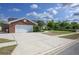This property features a brick facade, a two-car garage and beautifully maintained landscaping and driveway at 3306 Fishermans Cv, Winter Park, FL 32792