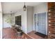 Inviting front porch with brick flooring, cozy seating, and decorative hanging lantern at 3306 Fishermans Cv, Winter Park, FL 32792