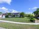 Well-maintained front yard featuring lush green grass, trimmed bushes, and a brick mailbox at 3306 Fishermans Cv, Winter Park, FL 32792