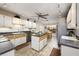 Bright kitchen with stone countertops, central island, and dining area at 3306 Fishermans Cv, Winter Park, FL 32792