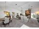 Open-concept living area with a fireplace, dining table, and abundant natural light at 3306 Fishermans Cv, Winter Park, FL 32792