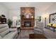 Cozy living room showcases a brick fireplace, plush seating, and stylish decor at 3306 Fishermans Cv, Winter Park, FL 32792