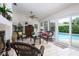Bright sun room featuring wicker furniture and a view of the pool at 3306 Fishermans Cv, Winter Park, FL 32792