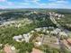 Wide aerial view of community with lush trees, community pool, and a view of the city at 35 Misners Trl, Ormond Beach, FL 32174