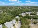 Aerial shot of community featuring mature trees, sparkling community pool, and well-kept townhomes at 35 Misners Trl, Ormond Beach, FL 32174