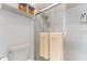 Bright bathroom showcasing tiled shower with glass door and built-in shelving at 35 Misners Trl, Ormond Beach, FL 32174