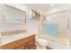 Bathroom with shower-tub combo featuring tiled walls, granite vanity, and modern fixtures at 35 Misners Trl, Ormond Beach, FL 32174