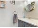 Charming half bathroom with custom mirror and vanity with marble countertop and coastal decor at 35 Misners Trl, Ormond Beach, FL 32174
