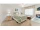 Cozy bedroom with a ceiling fan, a full bed, and a bright window at 35 Misners Trl, Ormond Beach, FL 32174