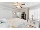 Bright bedroom features a bed with an ocean-themed duvet, and white walls at 35 Misners Trl, Ormond Beach, FL 32174