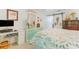 Bedroom showcasing a decorative comforter, office space, and colorful dresser at 35 Misners Trl, Ormond Beach, FL 32174