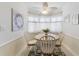 Cozy dining area with large windows, decorative curtains, and a ceiling fan at 35 Misners Trl, Ormond Beach, FL 32174