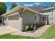 Attractive townhome showcasing a tidy yard, updated siding, and an attached garage at 35 Misners Trl, Ormond Beach, FL 32174