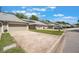 Street view of well-maintained townhomes with manicured lawns, garages, and neighborhood charm at 35 Misners Trl, Ormond Beach, FL 32174