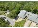 Aerial view of townhomes with manicured lawns, mature trees, and private driveways at 35 Misners Trl, Ormond Beach, FL 32174