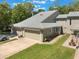 Aerial of townhome showcasing its well-manicured lawn, two-car garage, and architectural charm at 35 Misners Trl, Ormond Beach, FL 32174
