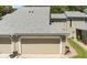 Charming townhome featuring a neutral exterior, updated roof, and two-car garage at 35 Misners Trl, Ormond Beach, FL 32174