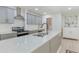 Bright kitchen featuring modern appliances, stone countertops, and grey cabinetry at 35 Misners Trl, Ormond Beach, FL 32174