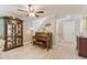 Inviting living room with hardwood floors, piano, and decorative display cabinet, all bathed in natural light at 35 Misners Trl, Ormond Beach, FL 32174