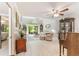 Well-lit living room with hardwood floors, comfortable seating, and access to a screened-in patio at 35 Misners Trl, Ormond Beach, FL 32174