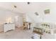 Spacious loft area with a view of the backyard, featuring vaulted ceilings and neutral carpet at 35 Misners Trl, Ormond Beach, FL 32174