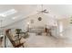 Comfortable loft area with vaulted ceilings, a sofa, rocking chairs, and natural light at 35 Misners Trl, Ormond Beach, FL 32174