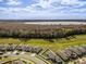 Beautiful aerial view of a residential community near a lake and conservation area on a sunny day at 3761 Shoveler Ave, Leesburg, FL 34748