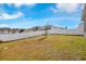 A well-maintained backyard, enclosed by a white fence, offers privacy and space for outdoor enjoyment at 3761 Shoveler Ave, Leesburg, FL 34748