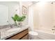 Bright bathroom featuring granite counters and a shower-tub combination at 3761 Shoveler Ave, Leesburg, FL 34748