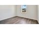 Empty bedroom featuring wood-look floors and bright window at 3761 Shoveler Ave, Leesburg, FL 34748