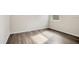 Empty bedroom featuring wood-look floors and bright window at 3761 Shoveler Ave, Leesburg, FL 34748
