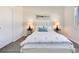 Bright bedroom featuring a queen-size bed, matching side tables, and a window at 3761 Shoveler Ave, Leesburg, FL 34748