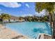 Large community pool featuring clear blue water, lined with lounge chairs for relaxing by the water at 3761 Shoveler Ave, Leesburg, FL 34748