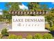 Elegant community sign for Lake Denham Estates, showcasing the entrance to the neighborhood with manicured landscaping at 3761 Shoveler Ave, Leesburg, FL 34748