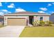 Charming single-story home with a well-manicured lawn and a two car garage at 3761 Shoveler Ave, Leesburg, FL 34748