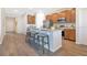 Spacious kitchen with wood cabinets, granite countertops, and an island with seating at 3761 Shoveler Ave, Leesburg, FL 34748