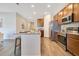 Modern kitchen features granite countertops, stainless steel appliances, and wood-look flooring at 3761 Shoveler Ave, Leesburg, FL 34748