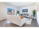 Bright living room showcasing a comfortable sofa, modern decor, and sliding glass doors at 3761 Shoveler Ave, Leesburg, FL 34748
