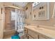 Bathroom featuring a vanity with good storage, a framed mirror and a shower-tub combo at 3790 Ne 22Nd Ave, Ocala, FL 34479