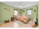 Cozy bedroom with tiled floors, a ceiling fan, and a well-lit window at 3790 Ne 22Nd Ave, Ocala, FL 34479