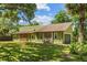 Charming single Gathering home showcasing stone accents and a large, well-manicured lawn at 3790 Ne 22Nd Ave, Ocala, FL 34479