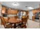 Eat-in kitchen featuring wood cabinets, stainless steel appliances, and a cozy breakfast nook at 3790 Ne 22Nd Ave, Ocala, FL 34479